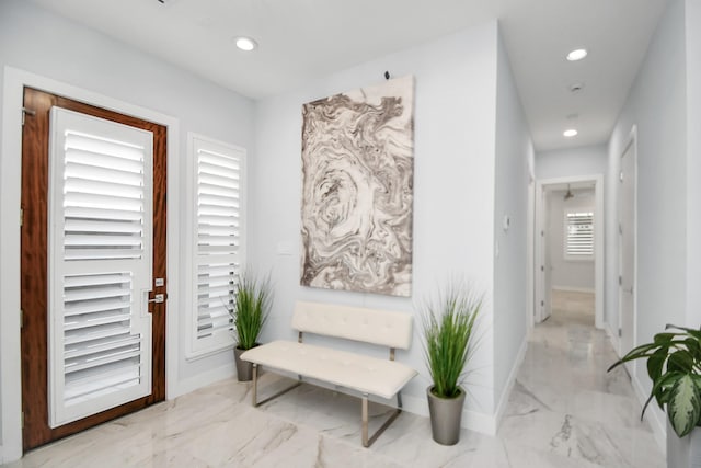 corridor featuring recessed lighting, marble finish floor, and baseboards