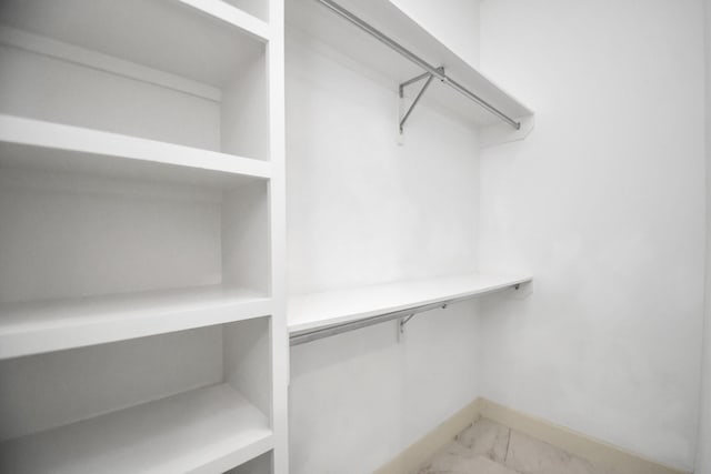 spacious closet with marble finish floor