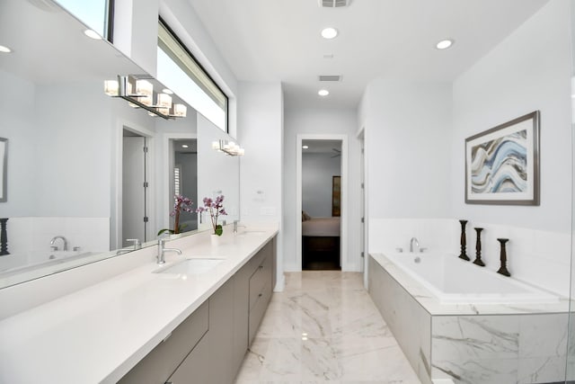 full bath featuring visible vents, a garden tub, and a sink