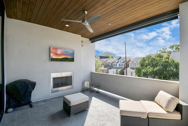 view of patio featuring a residential view, a balcony, and a ceiling fan