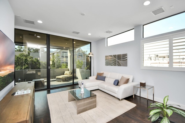 living room featuring visible vents, wood finished floors, and expansive windows