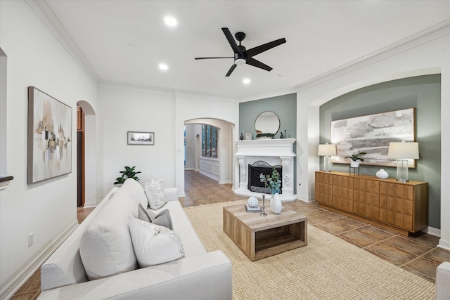 living room featuring crown molding, recessed lighting, arched walkways, and ceiling fan