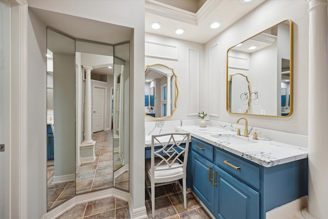 bathroom with recessed lighting, decorative columns, and vanity