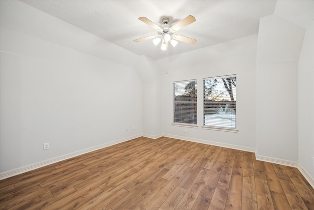 spare room featuring ceiling fan, baseboards, and hardwood / wood-style flooring