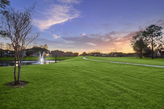 view of home's community featuring a yard and a water view