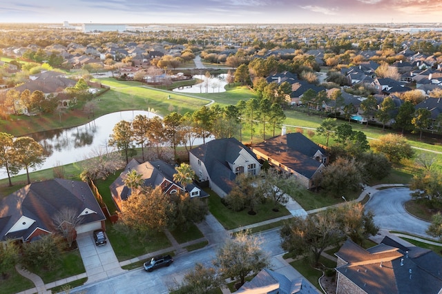 birds eye view of property with a residential view and a water view