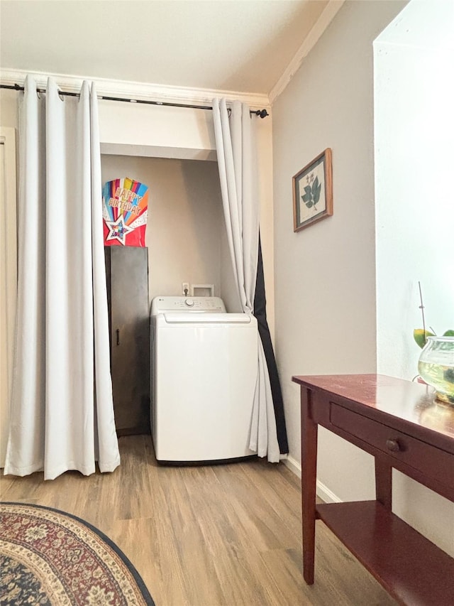 washroom featuring washer / dryer, laundry area, and light wood-style floors