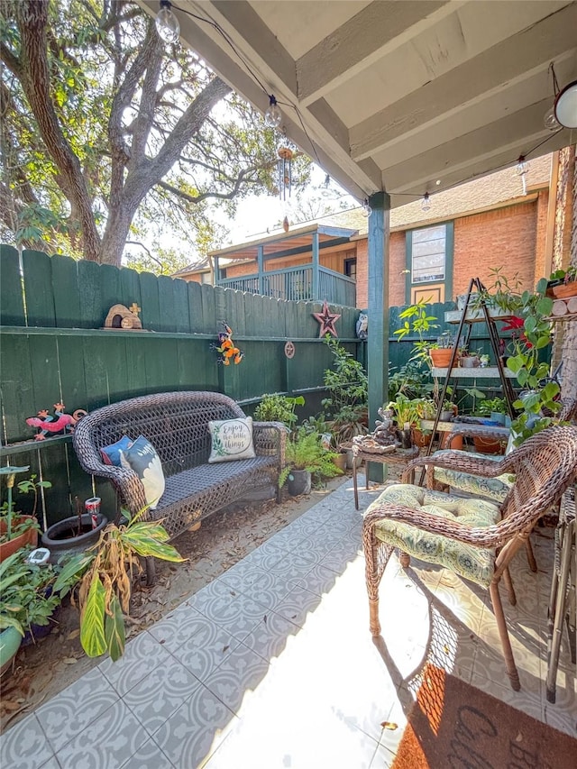 view of patio / terrace featuring fence