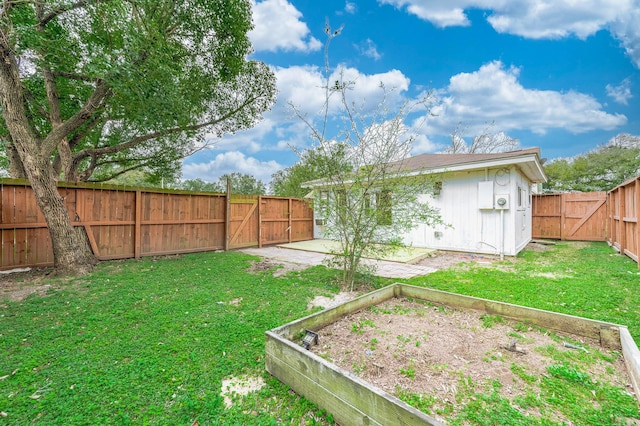 view of yard featuring a garden, a fenced backyard, and a patio