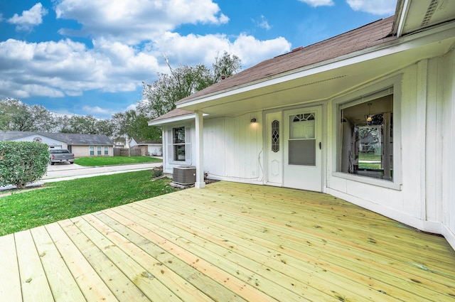 deck with a lawn and central air condition unit