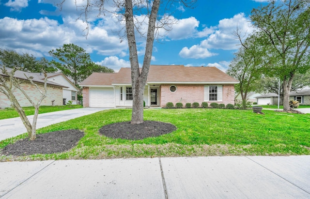 single story home with concrete driveway, brick siding, a front lawn, and an attached garage