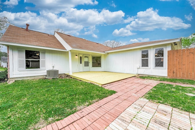 back of property with a patio area, a lawn, fence, and central air condition unit