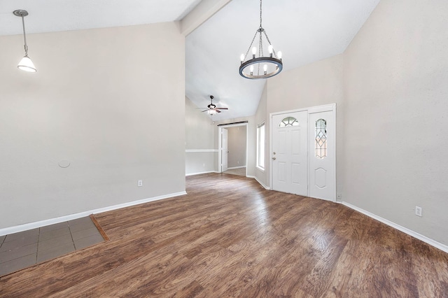 foyer entrance featuring high vaulted ceiling, ceiling fan with notable chandelier, wood finished floors, baseboards, and beam ceiling