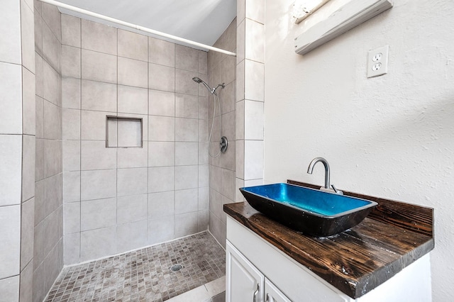 bathroom with a stall shower and vanity