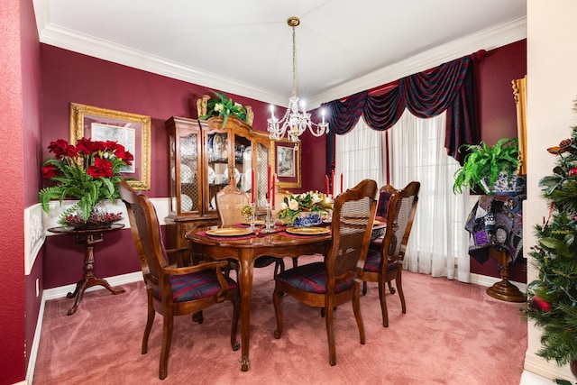 carpeted dining area featuring baseboards, ornamental molding, and a notable chandelier