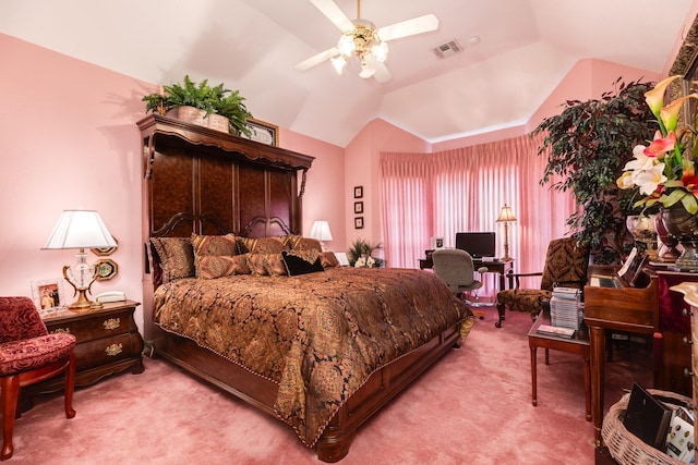 carpeted bedroom featuring lofted ceiling, visible vents, and a ceiling fan