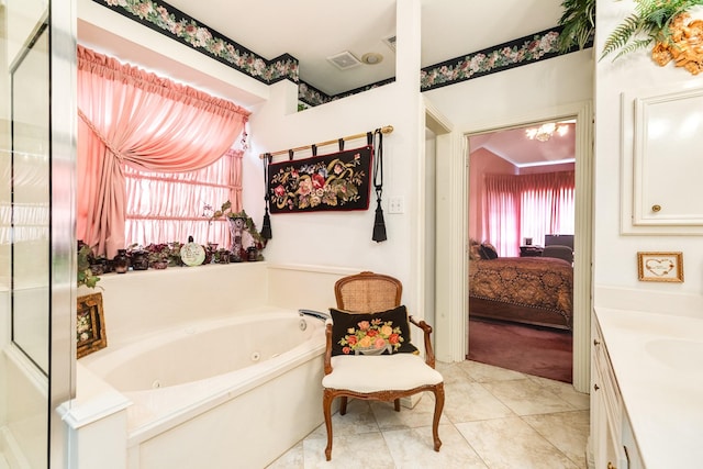 ensuite bathroom featuring visible vents, a tub with jets, ensuite bathroom, tile patterned flooring, and vanity