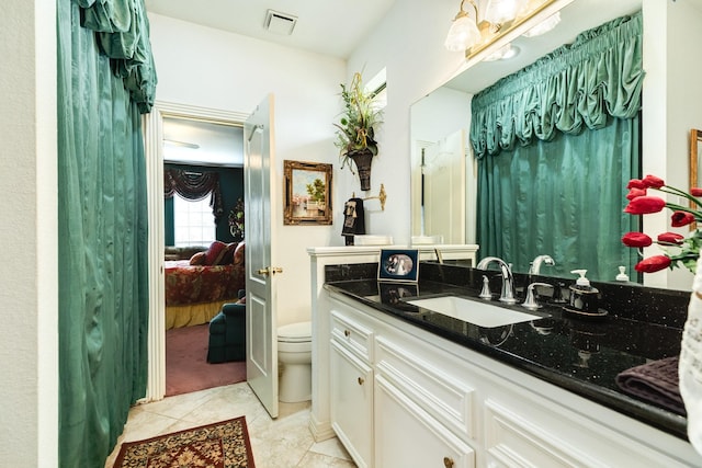 ensuite bathroom featuring ensuite bathroom, tile patterned flooring, toilet, vanity, and visible vents