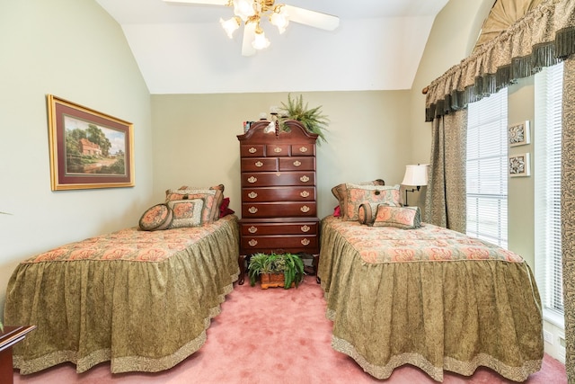 carpeted bedroom with a ceiling fan and vaulted ceiling