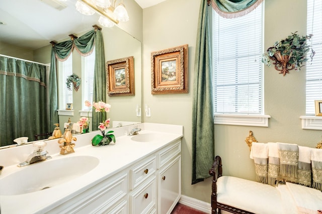 full bathroom with visible vents, a sink, baseboards, and double vanity