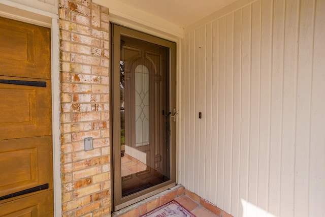 property entrance featuring brick siding