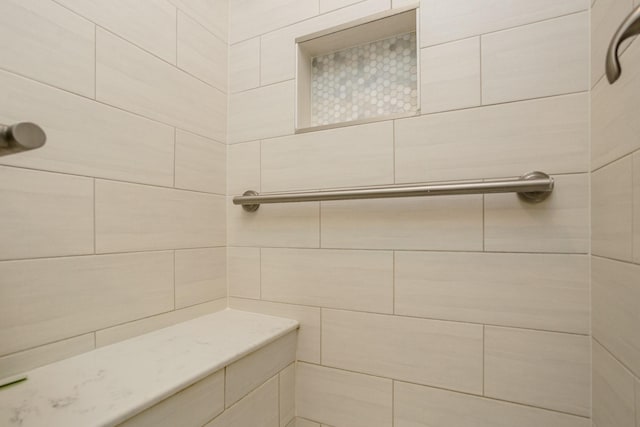 bathroom with tiled shower