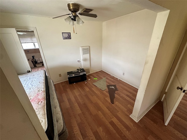 unfurnished bedroom featuring visible vents, ceiling fan, and wood finished floors