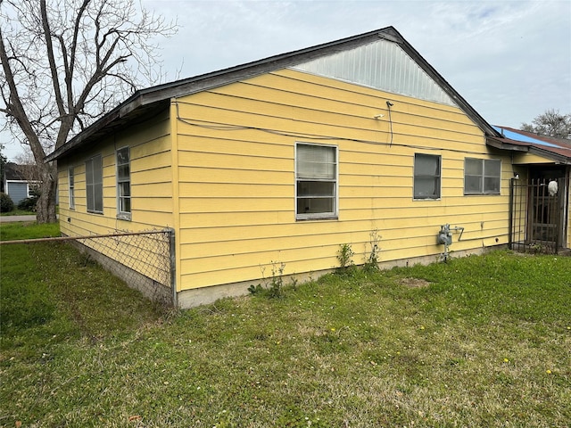 view of property exterior with a lawn