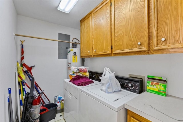 clothes washing area featuring water heater, electric panel, cabinet space, and washer and dryer