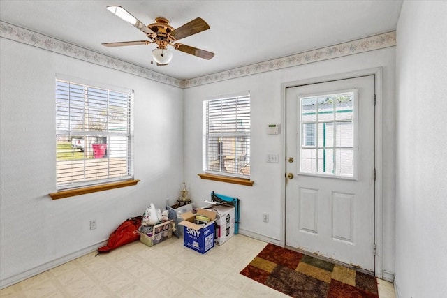 entryway featuring a ceiling fan and tile patterned floors