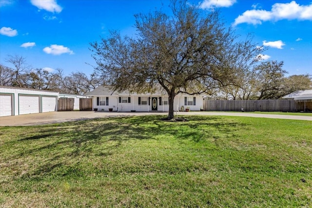 view of front of property with fence, covered porch, a front yard, and a garage