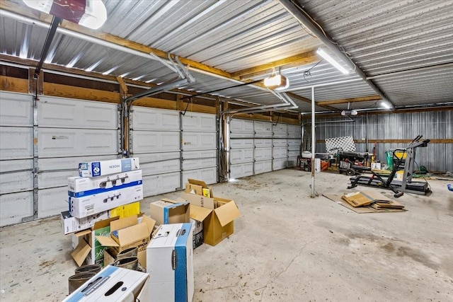 garage featuring a garage door opener and metal wall