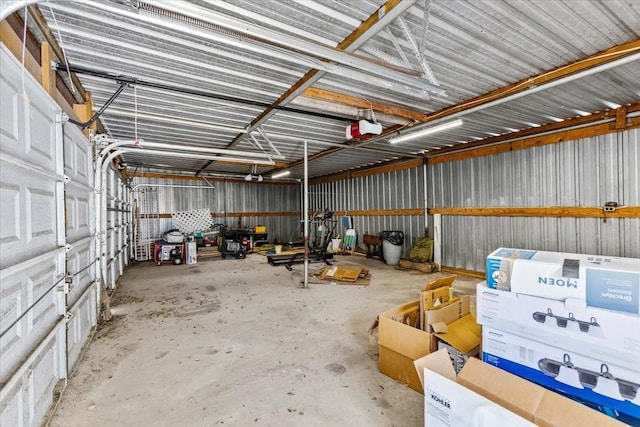 garage featuring metal wall and a garage door opener