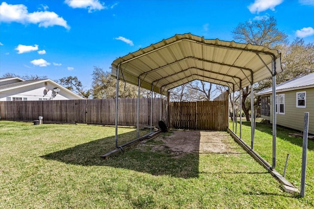 view of yard featuring a detached carport and fence