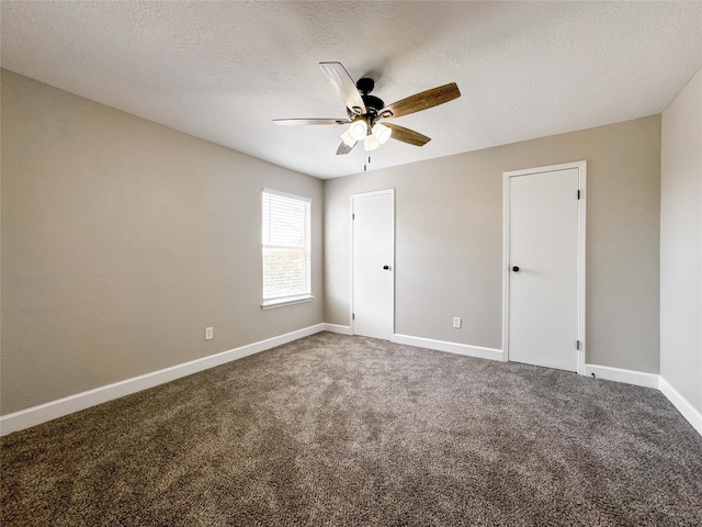 unfurnished room featuring a ceiling fan, carpet, a textured ceiling, and baseboards