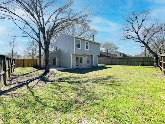 view of yard with french doors and a fenced backyard