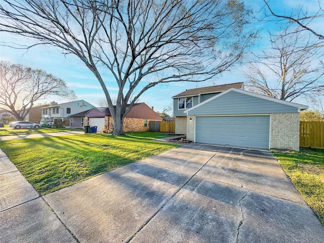 view of front facade featuring brick siding, fence, a garage, driveway, and a front lawn