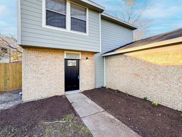 view of exterior entry with fence