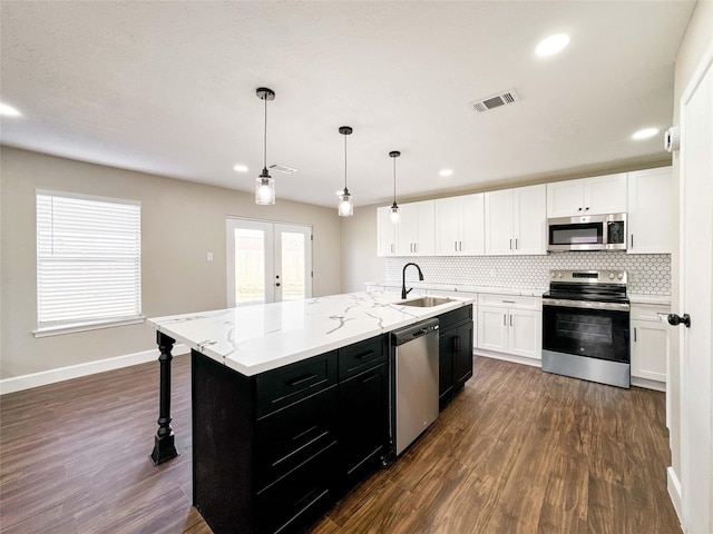 kitchen featuring a sink, visible vents, french doors, appliances with stainless steel finishes, and dark cabinetry