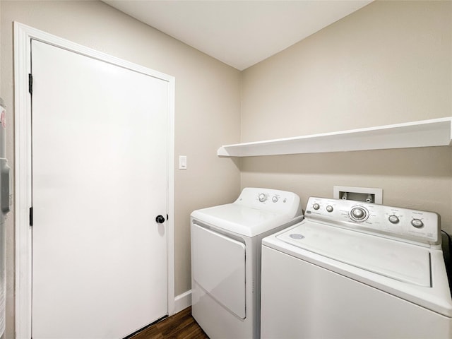 washroom with laundry area, dark wood-type flooring, and independent washer and dryer