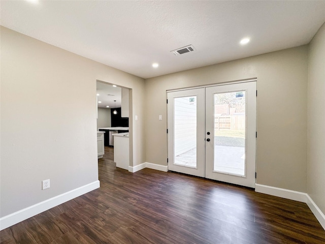 entryway featuring french doors, dark wood finished floors, visible vents, and baseboards