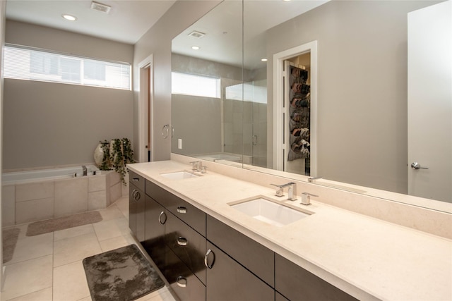 full bath with a shower stall, double vanity, visible vents, and a sink