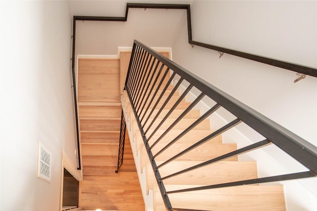 stairway featuring wood finished floors