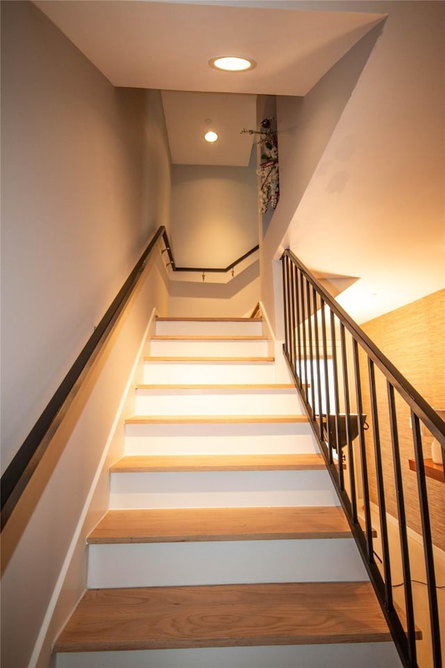 staircase featuring recessed lighting