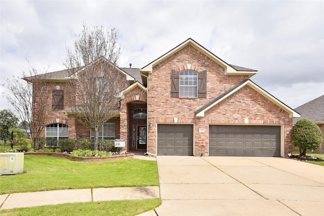 traditional-style home with a front lawn, a garage, brick siding, and driveway