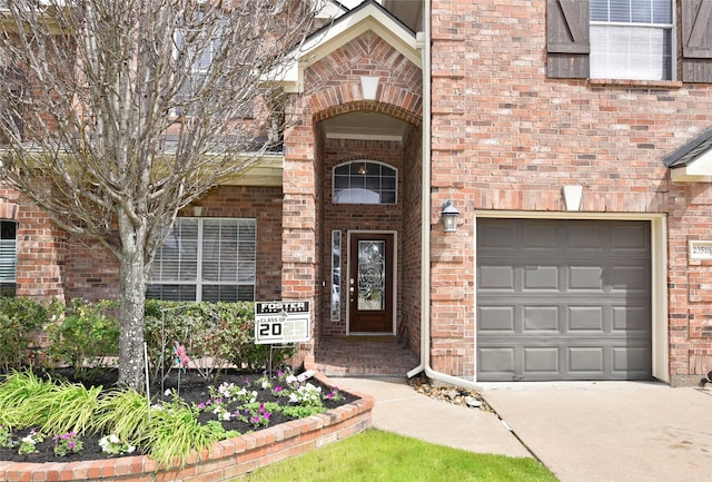 property entrance featuring brick siding and a garage