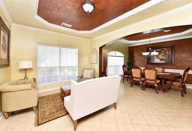 living area with visible vents, a chandelier, light tile patterned flooring, arched walkways, and a raised ceiling