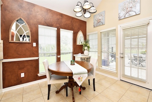 dining area with baseboards, a healthy amount of sunlight, a chandelier, and tile patterned flooring