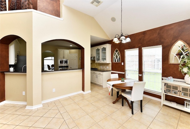 dining space featuring visible vents, baseboards, an inviting chandelier, and light tile patterned flooring