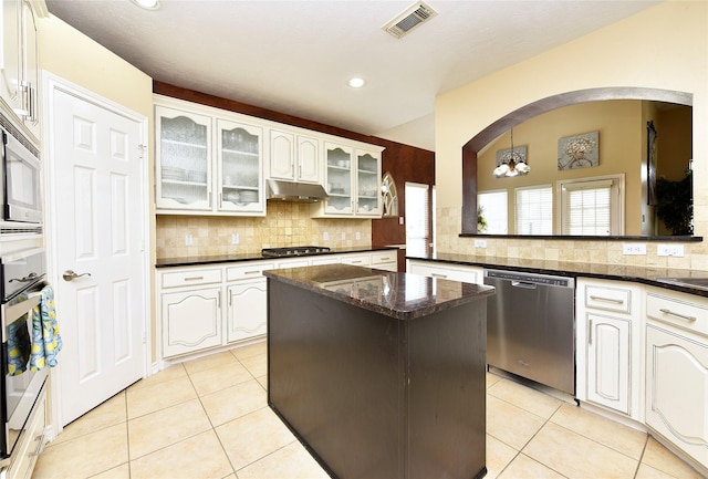 kitchen featuring light tile patterned floors, tasteful backsplash, and stainless steel appliances